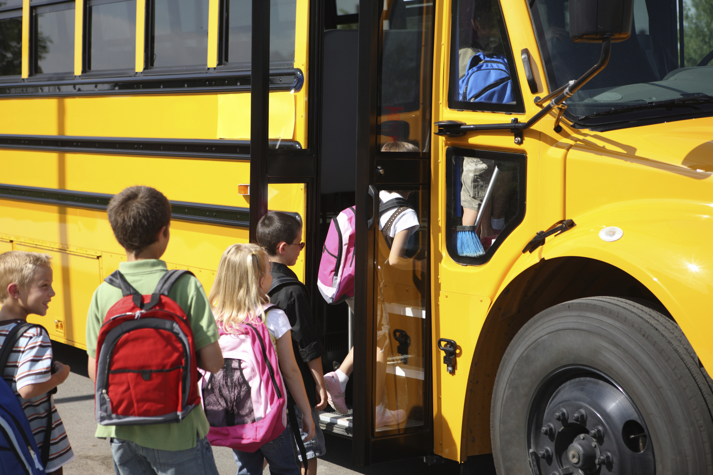 Kids entering a school shuttle
